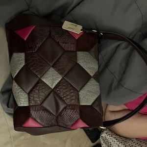Coach purse and it’s about medium size and it has pink and purple